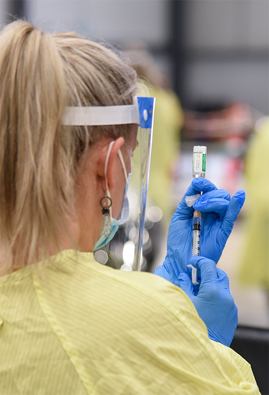 woman holding a vaccine image