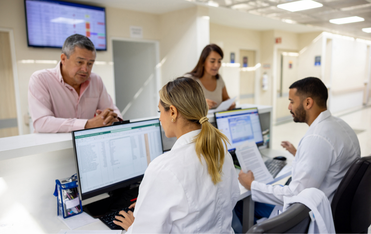 Nurses at their desk looking at their scheduling system.