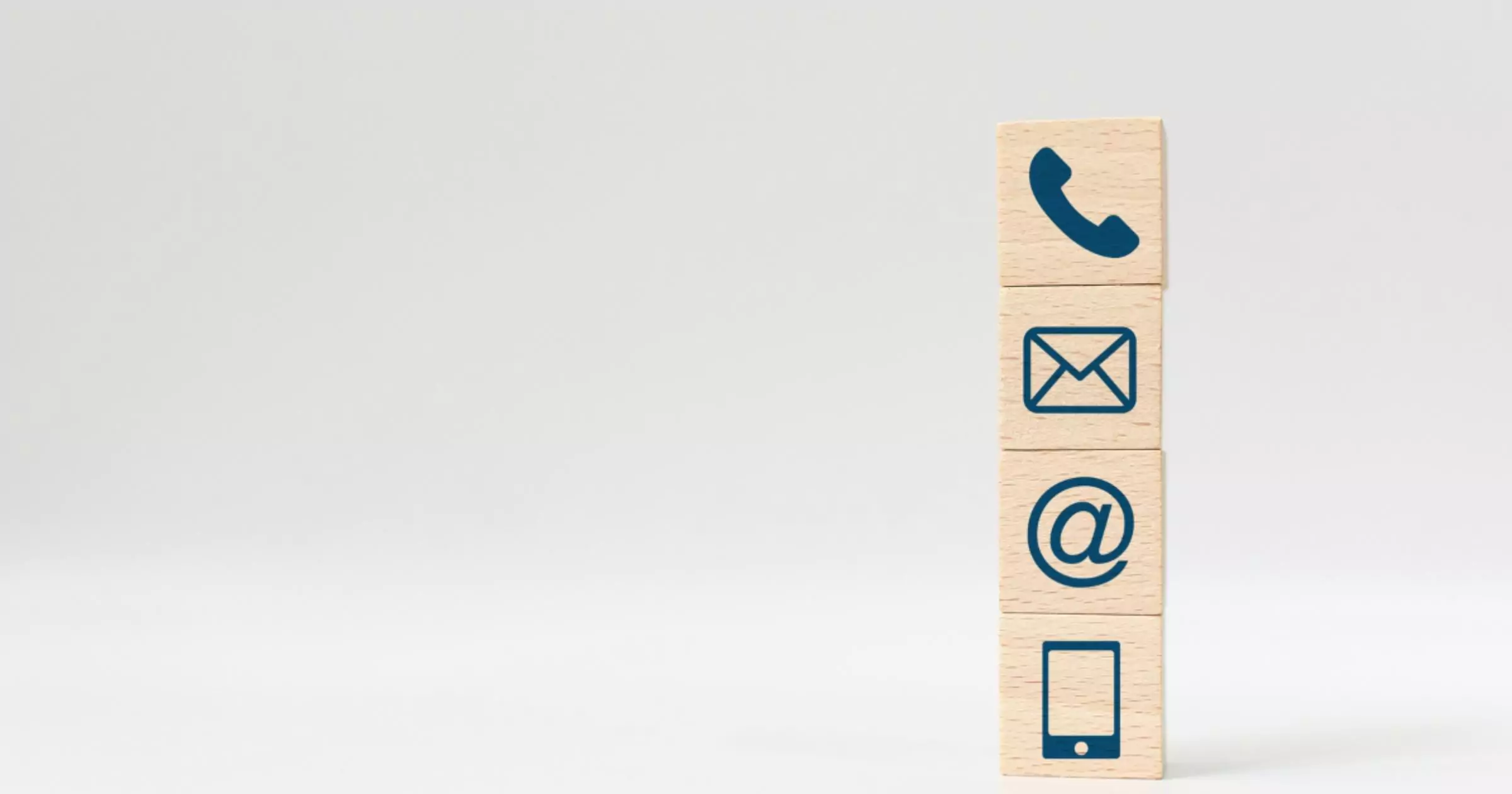 wooden blocks stacked with telephone email internet and mobile symbol