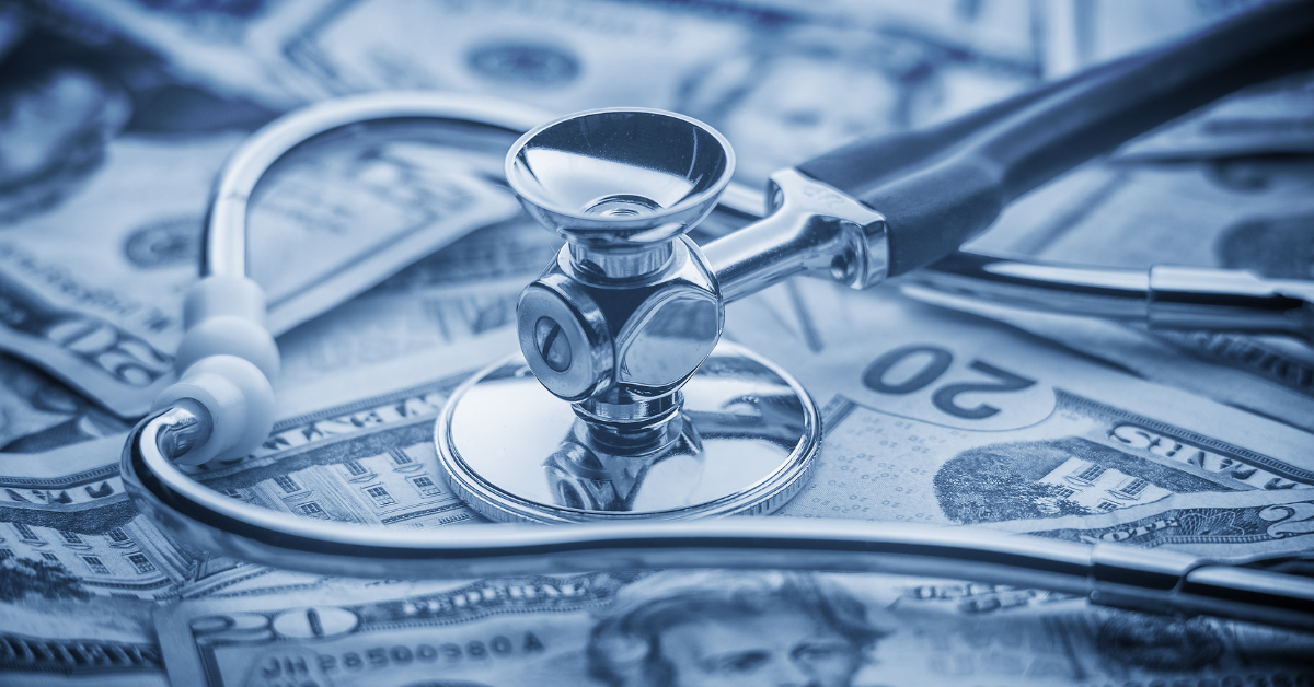 stethoscope on dollar bills illustrating healthcare cost concept image