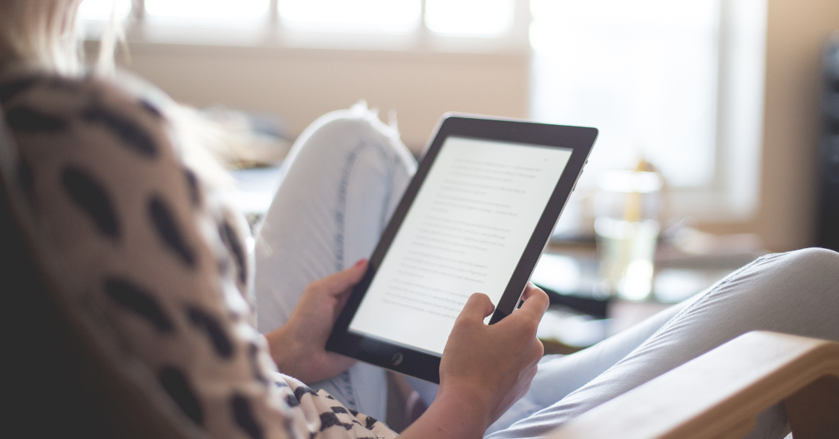 woman reading ebook on a tablet