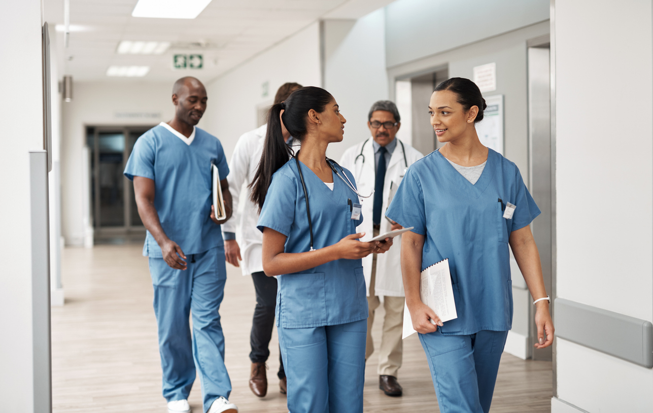 Healthcare professionals collaborating and adapting to changing staffing requirements.