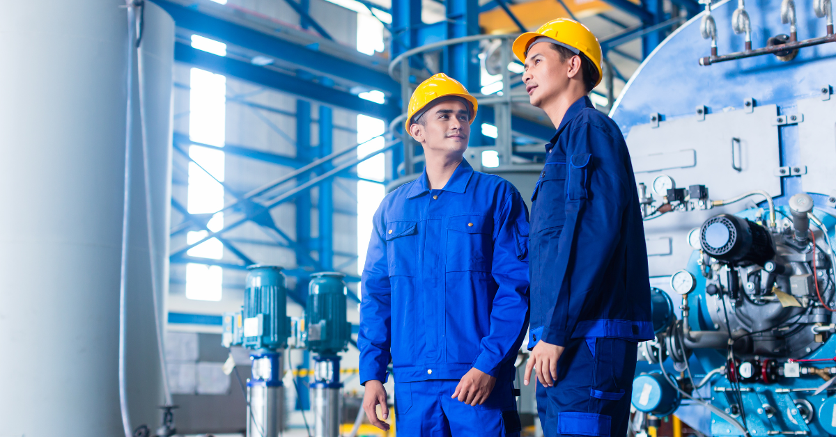 two workers in manufacturing plant